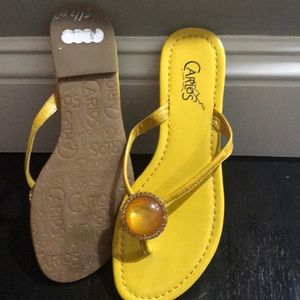 Flat plate thong sandal by Carlos Santana.